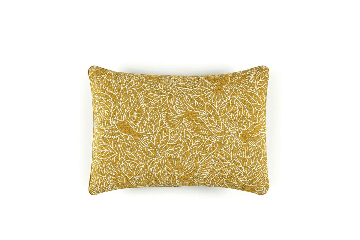 Yellow pillow with leaf pattern on a white background