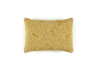 Yellow pillow with leaf pattern on a white background