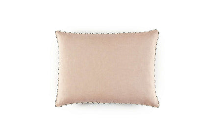 Beige pillow with decorative trim on a white background