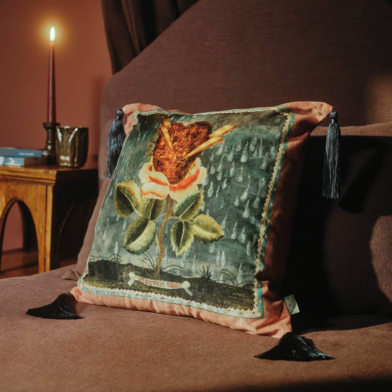 Decorative pillow with floral design on a brown couch